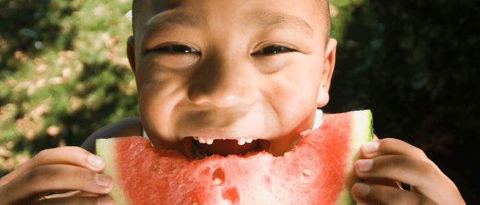 kid eating fruit