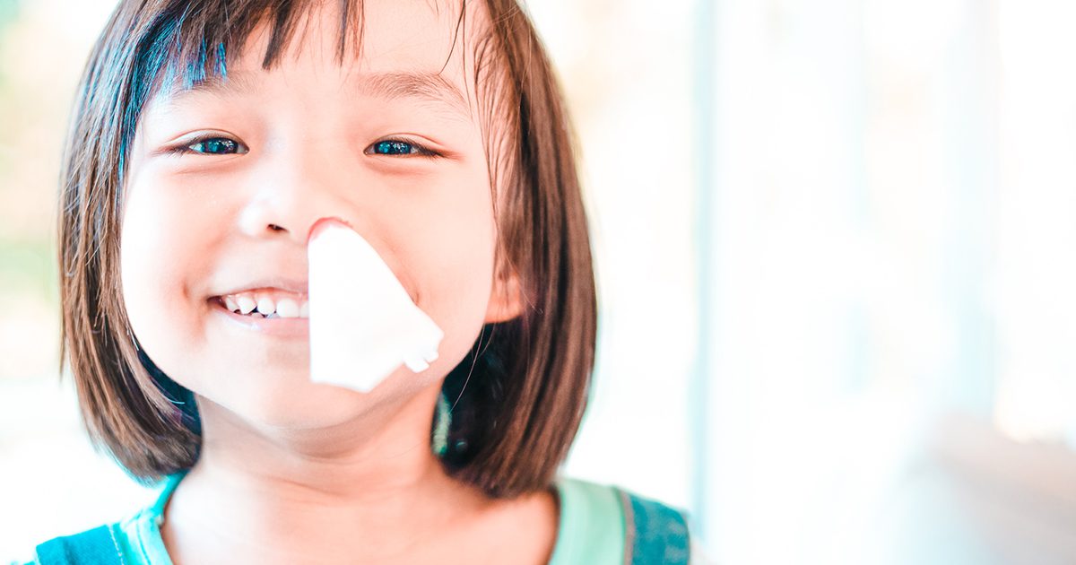 little girl with tissue in her nose