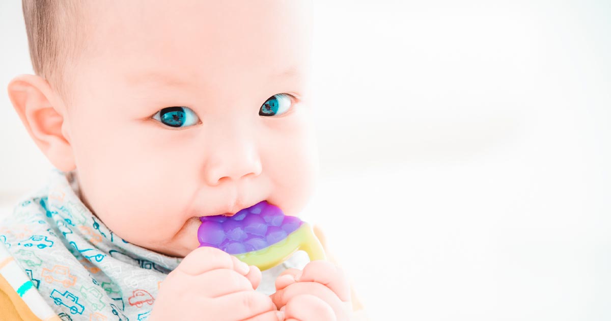 baby with teething toy