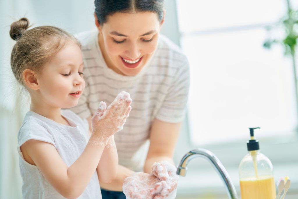 Mother and child washing their hands