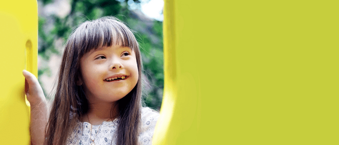 child with mosaic down syndrome smiling
