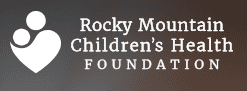 Logo for Rocky Mountain Children’s Health Foundation, featuring stylized white silhouettes of an adult and child within a heart shape on a dark gradient background, with the organization’s name in white text.